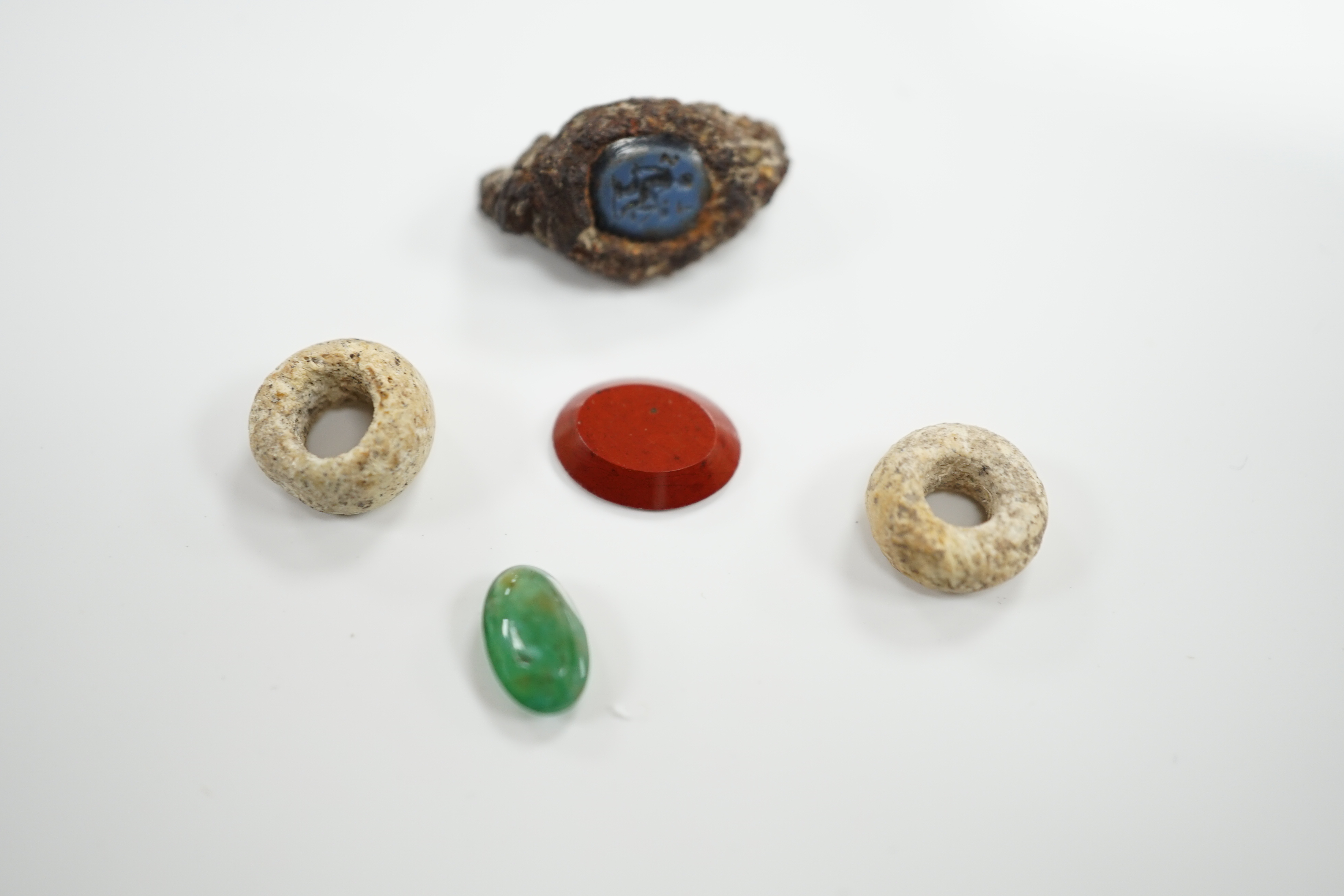 Three antique oval hardstone intaglios, including Roman?, carved with figures or cockerel, largest 10mm and two other items.